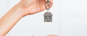 Handing Back the Keys to the old House and Moving on Closeup shot of a female hand receiving house key. Woman buying new home. Close up hand holding house key.