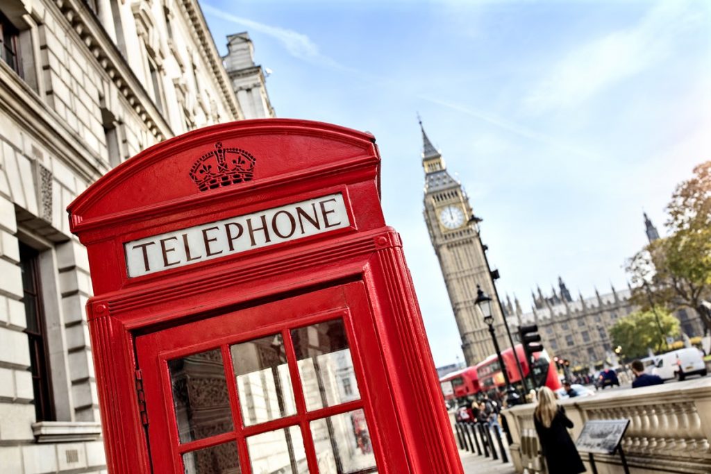 London telephone booth in front of  big ben and the houses of parliament in England